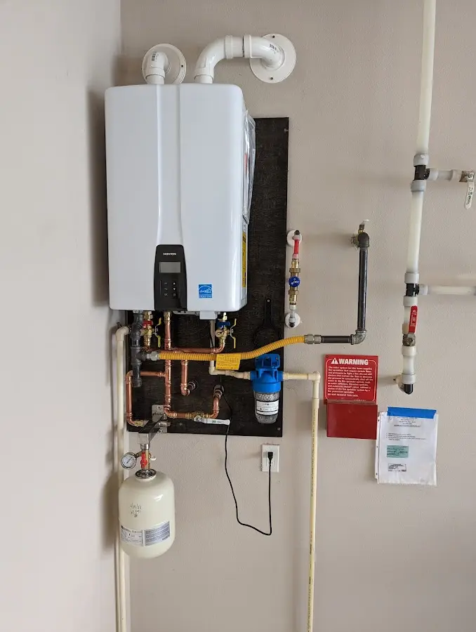 Professional plumber installing copper piping in a West Des Moines home